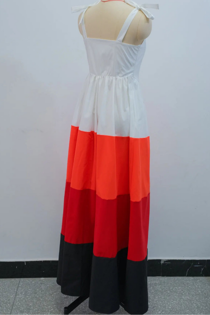 White, red, and black dress on a mannequin against a white background