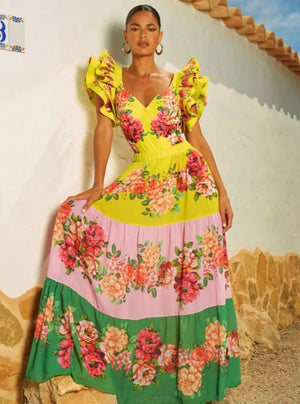 A woman wearing a colorful floral print one-piece swimsuit with ruffles, featuring a V-neckline and short sleeves.