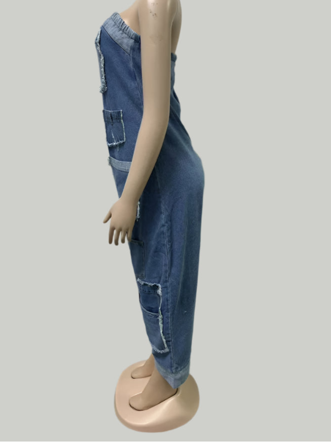 Mannequin wearing a blue denim jumpsuit against a plain white wall.