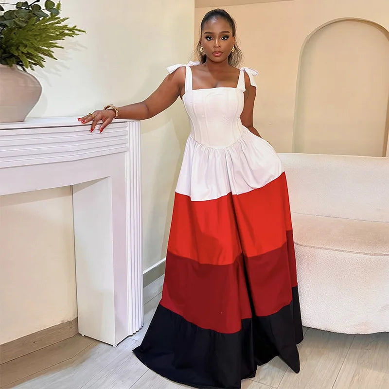 Woman wearing a white, red, and black dress in an indoor setting.