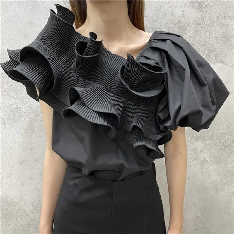 A mannequin displaying a white skew collar blouse with irregular ruffles and puff short sleeves.