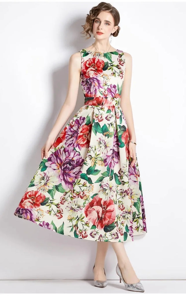 A model wearing a sleeveless, floral print, A-line midi dress with an empire waistline.