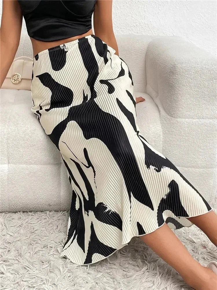 Person wearing a black and white patterned skirt on a light gray background