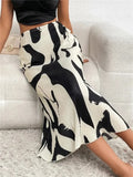 Person wearing a black and white patterned skirt on a light gray background