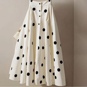 White skirt with black polka dots on a hanger against a beige background, featuring the brand 'JoinYouth'.