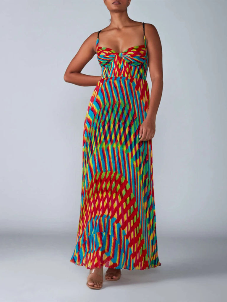 Woman wearing a colorful patterned dress on a plain background