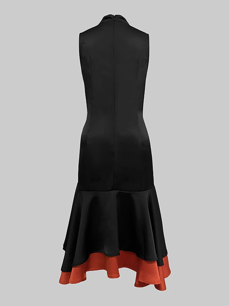 Black dress with a red hem on a gray background