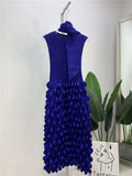 Blue dress with floral details on a hanger against a light background
