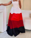 Woman wearing a white, red, and black dress in an indoor setting.