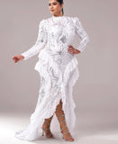 Woman wearing a white lace dress with floral patterns on a gray background