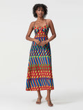 Woman wearing a colorful patterned dress on a white background