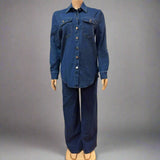 Mannequin wearing a blue denim outfit against a white curtain background