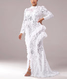 Woman wearing a white lace dress with long sleeves on a gray background