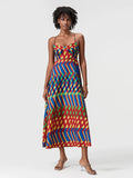 Woman wearing a colorful patterned dress on a white background