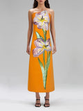 Woman wearing a strapless dress with floral design on a plain background