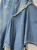 Blue denim garment with lace detailing on a plain background