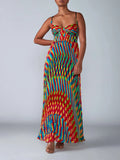 Woman wearing a colorful patterned dress on a plain background