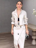 Woman wearing a white outfit with a gray background