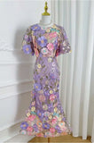 Floral dress on a mannequin against a white curtain background
