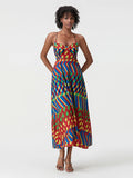 Woman wearing a colorful patterned dress on a white background